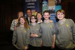 The school that came third, Comberton Village School, holding the trophy (presented to the Librarian) by Softlink